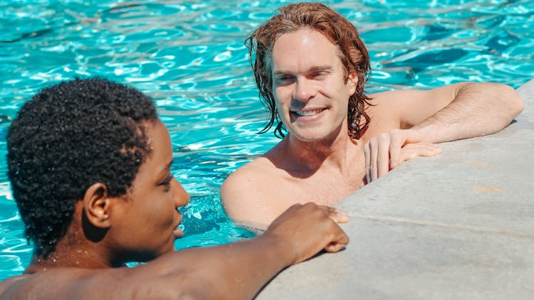 Man And Woman Talking In The Swimming Pool