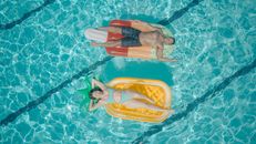Man and Woman Swimming in the Pool