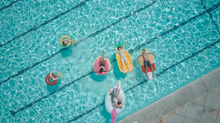 Top View Of People Swimming In The Pool