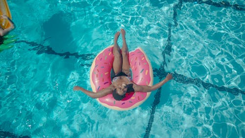 Free Woman on a Pink Swim Ring Stock Photo