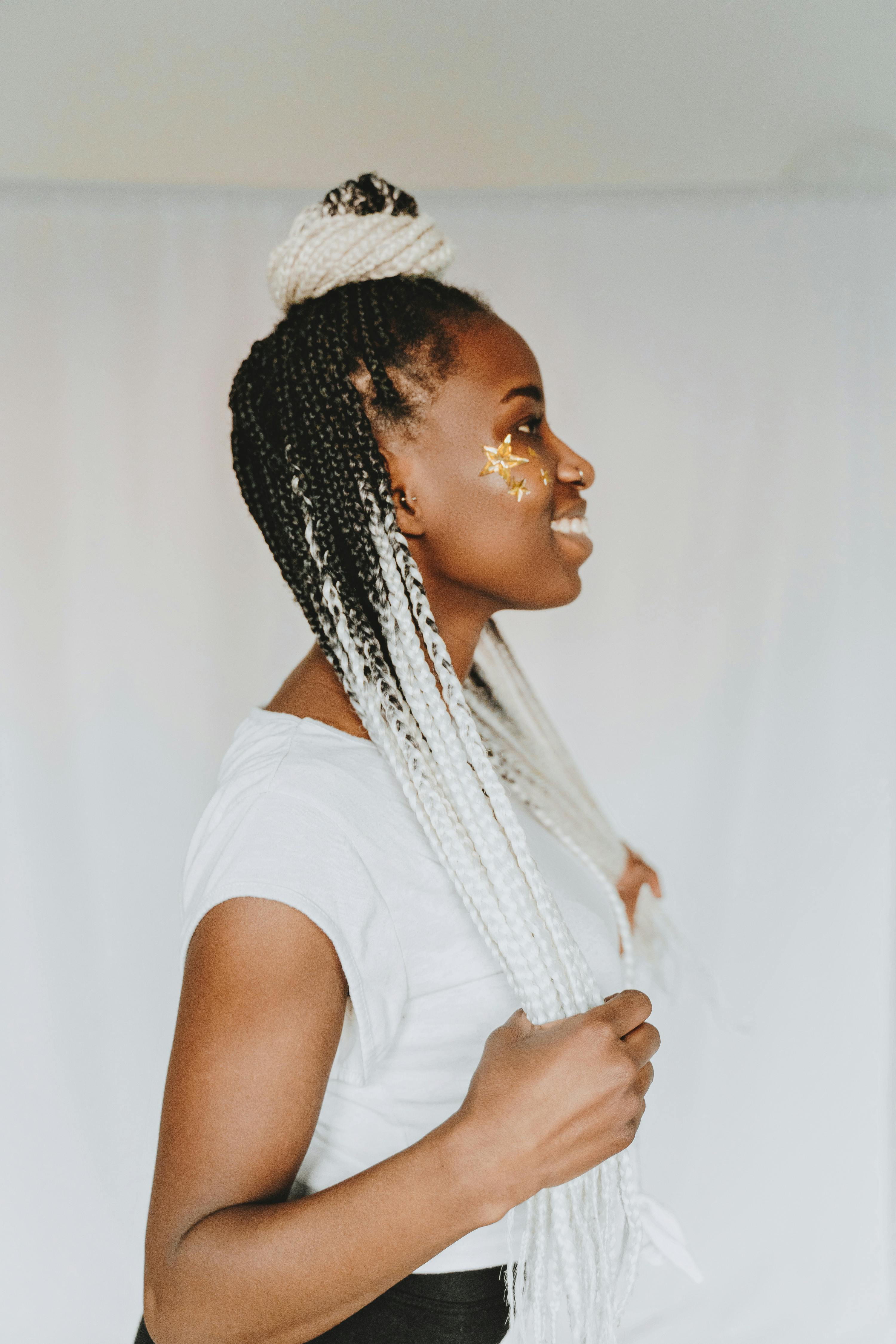 woman in white t shirt with braided hair