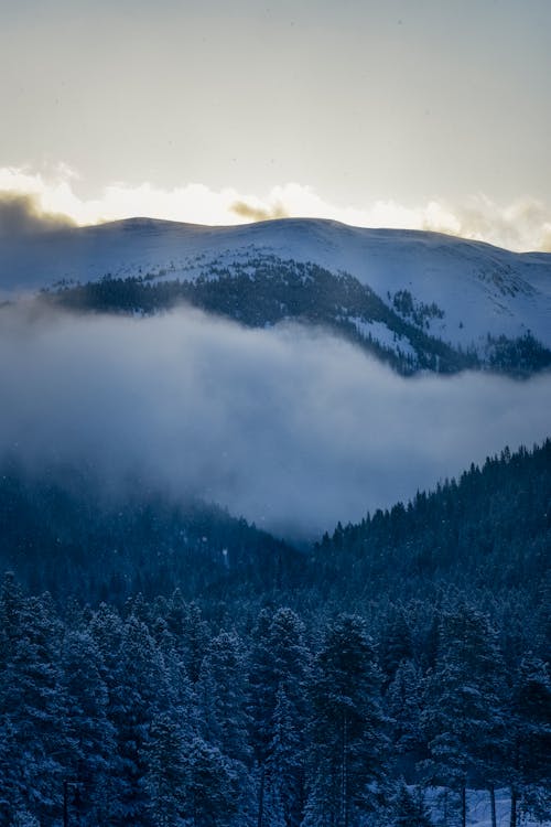 Free Mountains with Snow and Covered with Clouds Stock Photo