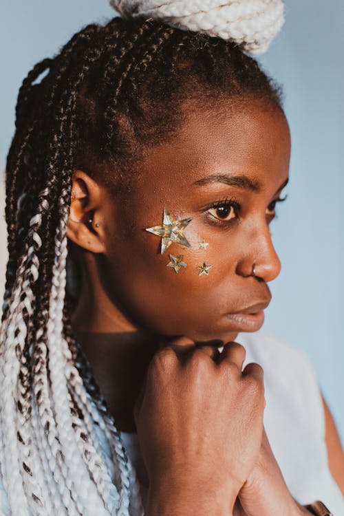 A Braided Haired Woman with Stars on Her Face