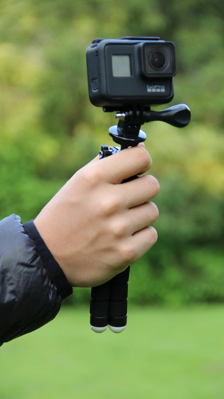 Hand Holding Black Go Pro