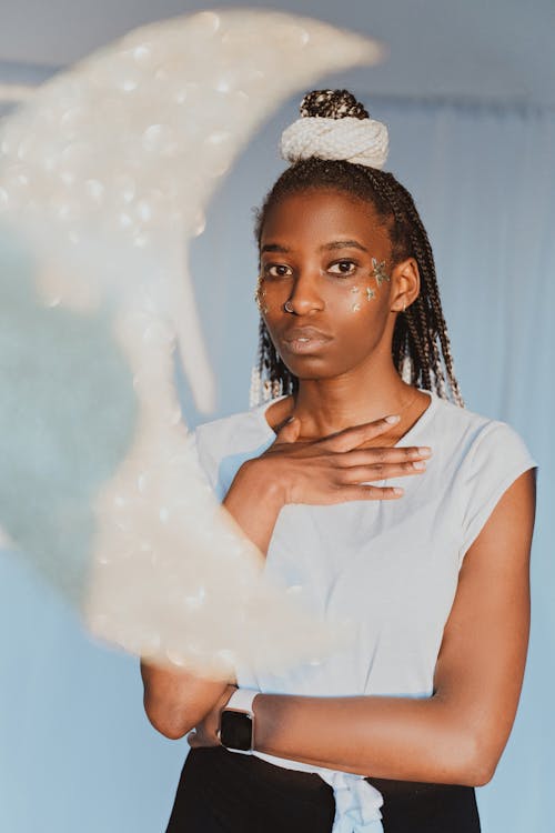 A Woman in White Shirt Holding Her Chest