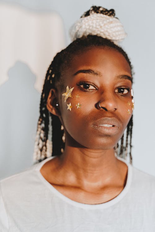 Woman with Gold Cut Out Stars on Cheek