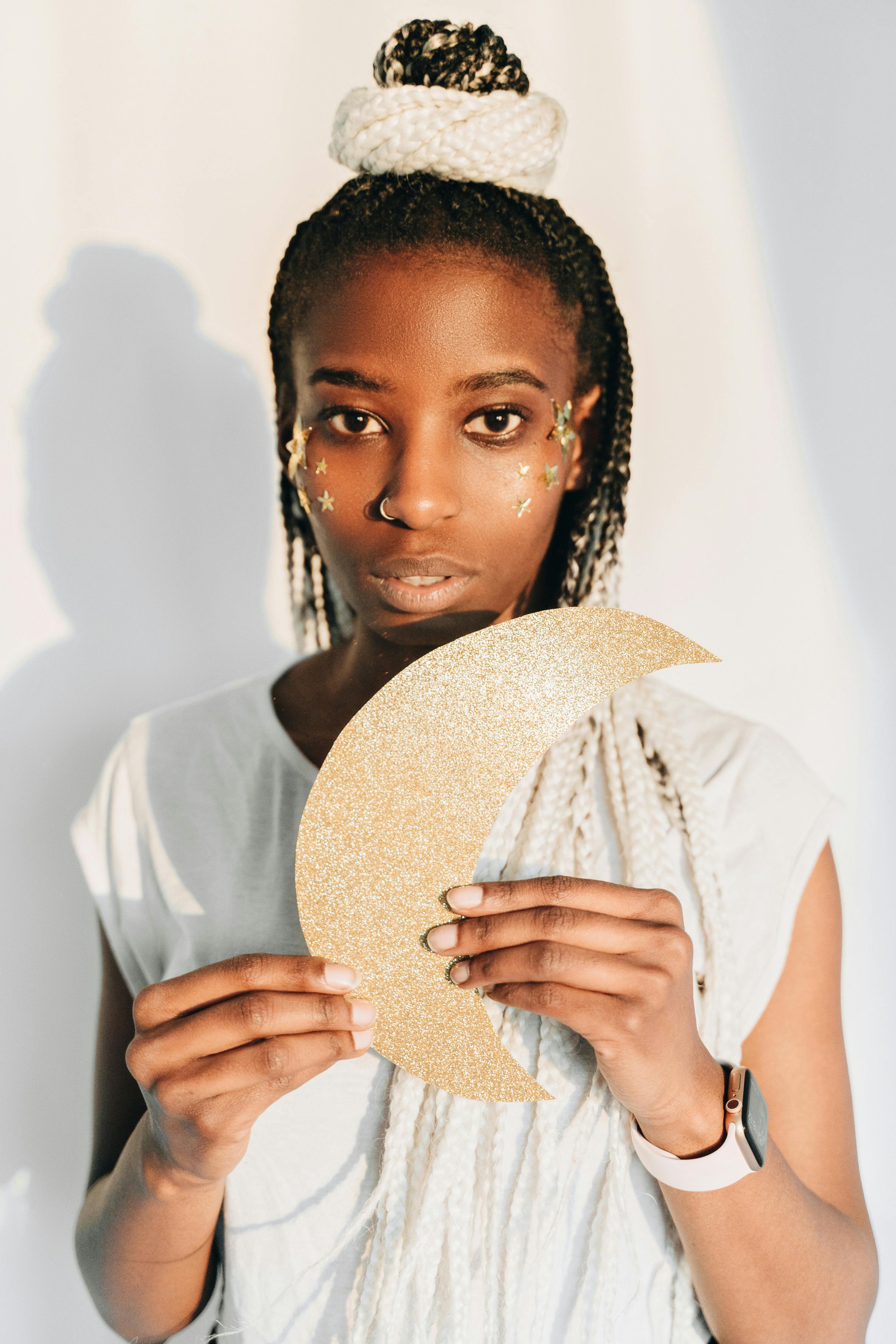 a woman holding glittery paper