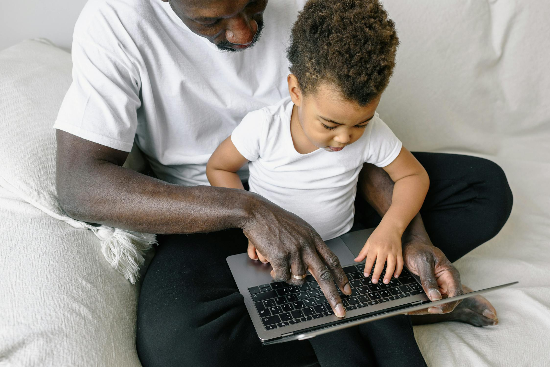 Father and Child Typing on Laptop · Free Stock Photo