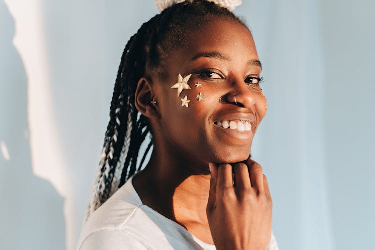 Woman With Stars On Cheek Smiling