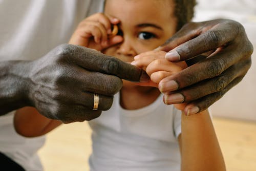 Free Close up of a Father Holding his Son's Hand Stock Photo