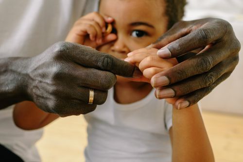 Free A close-up of a father holding his child's hand, symbolizing love and connection. Stock Photo