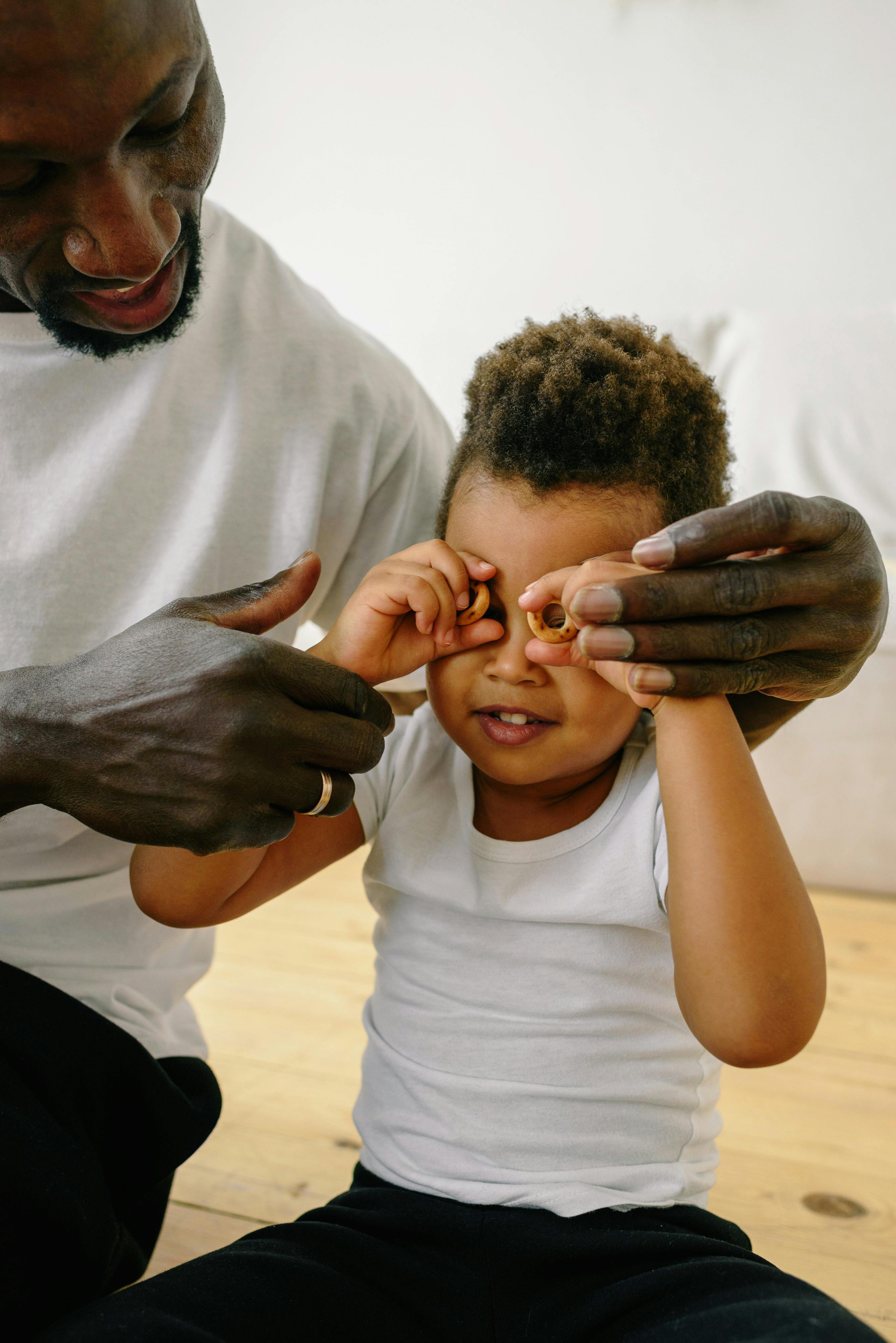 A touching moment of a father and son playing and bonding indoors.