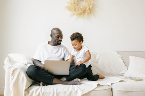 A Man and a Young Boy Sitting on the Sofa