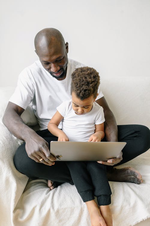 Free Father and Son Using a Laptop Stock Photo