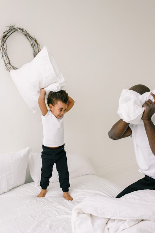 Free A Father and Son Doing Pillow Fight Stock Photo