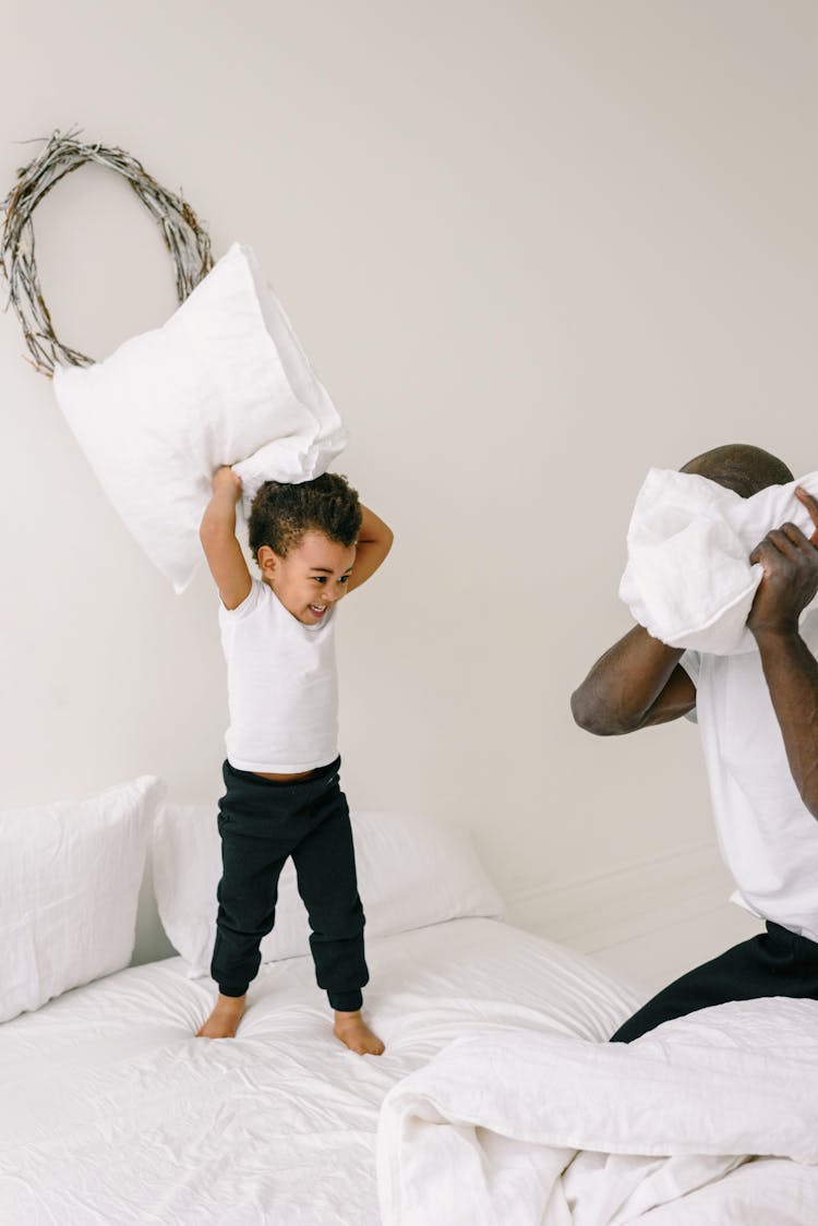 A Father And Son Doing Pillow Fight