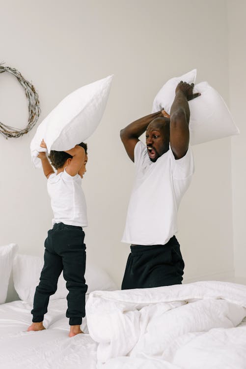 A Father and Son Doing Pillow Fight