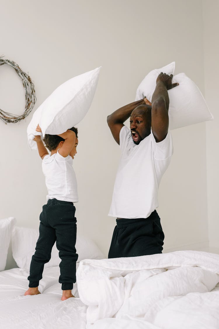 A Father And Son Doing Pillow Fight