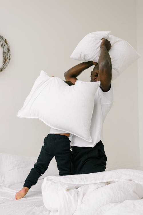 A Father and Son Doing Pillow Fight