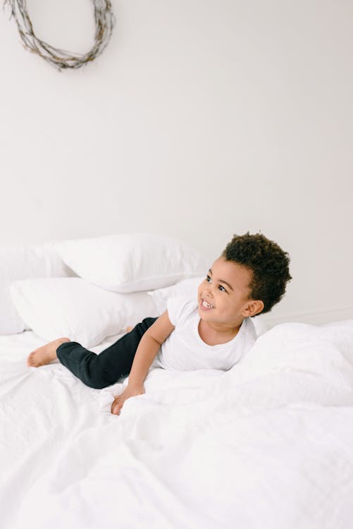Boy Playing on the Bed · Free Stock Photo