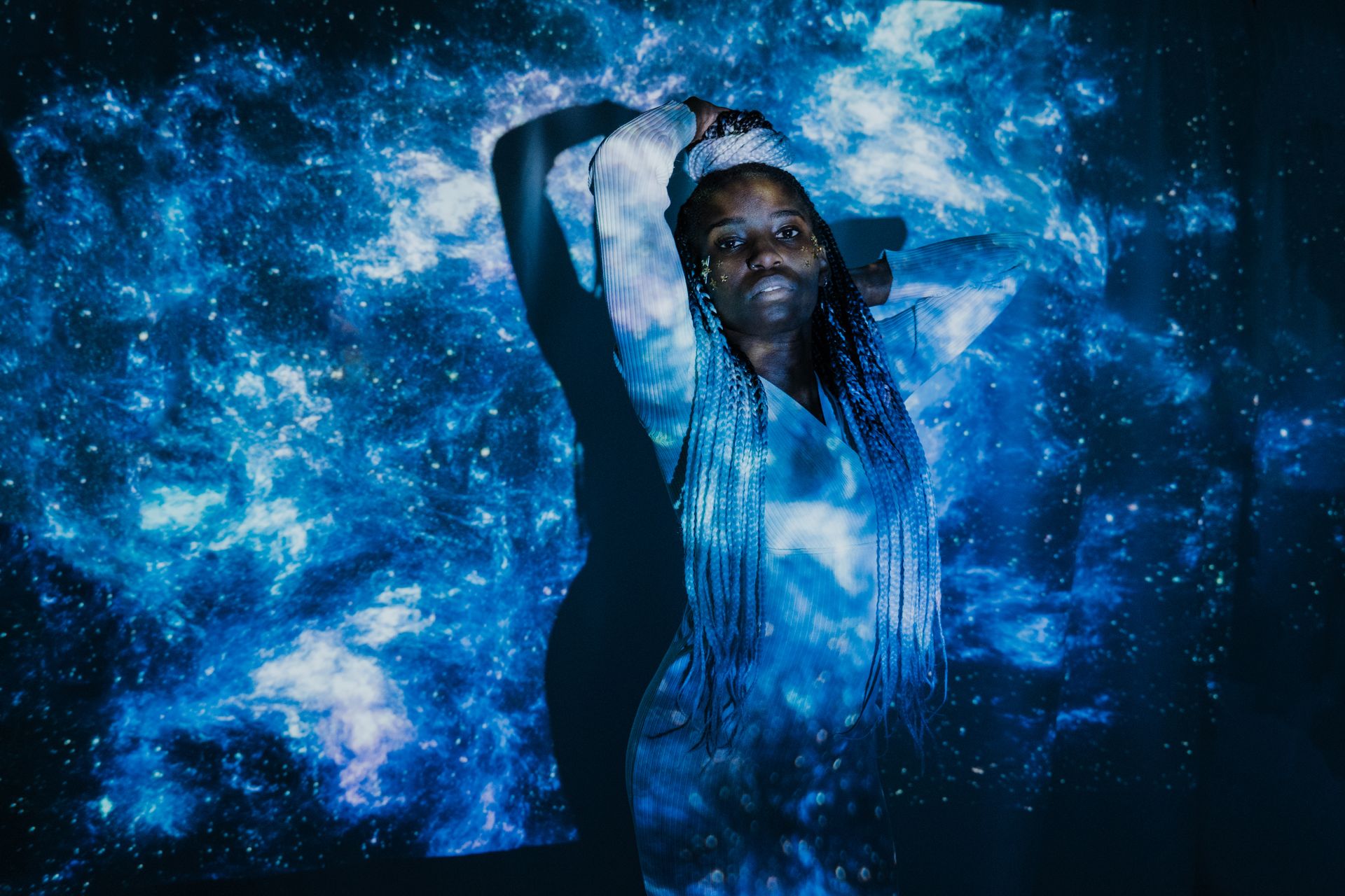 Captivating double exposure portrait blending a woman with a cosmic galaxy scene.