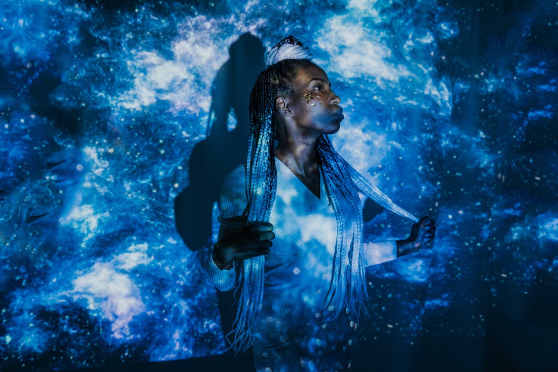 A Woman Standing in Front of a Projected Image · Free Stock Photo