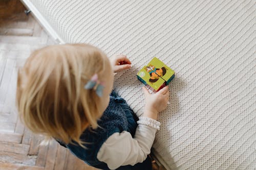 A Child Playing with a Block Puzzle