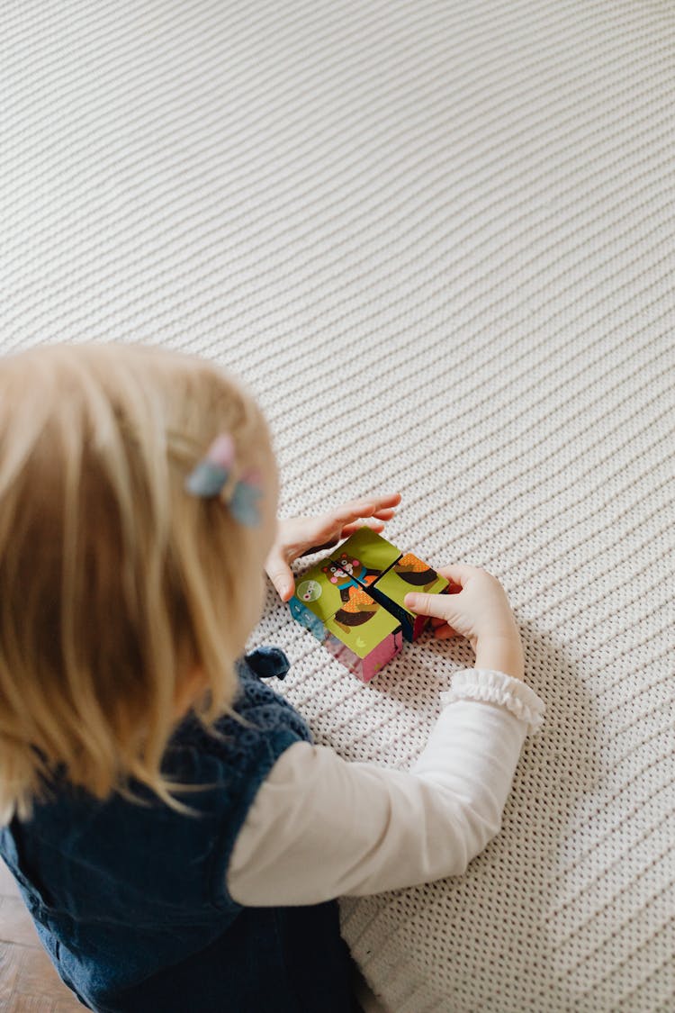 A Girl Playing A Puzzle Blocks