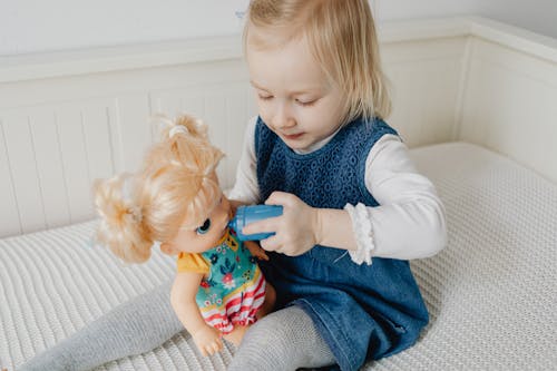 Free Girl Playing with her Doll Stock Photo