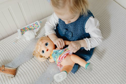 Free A Young Girl Playing Baby Doll Stock Photo