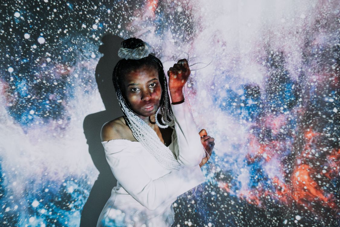 A Model Standing in Front of a Projected Image · Free Stock Photo