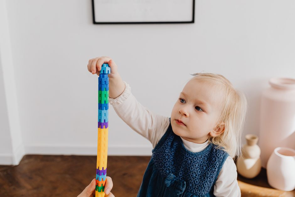 toddler concentrating playing blocks
