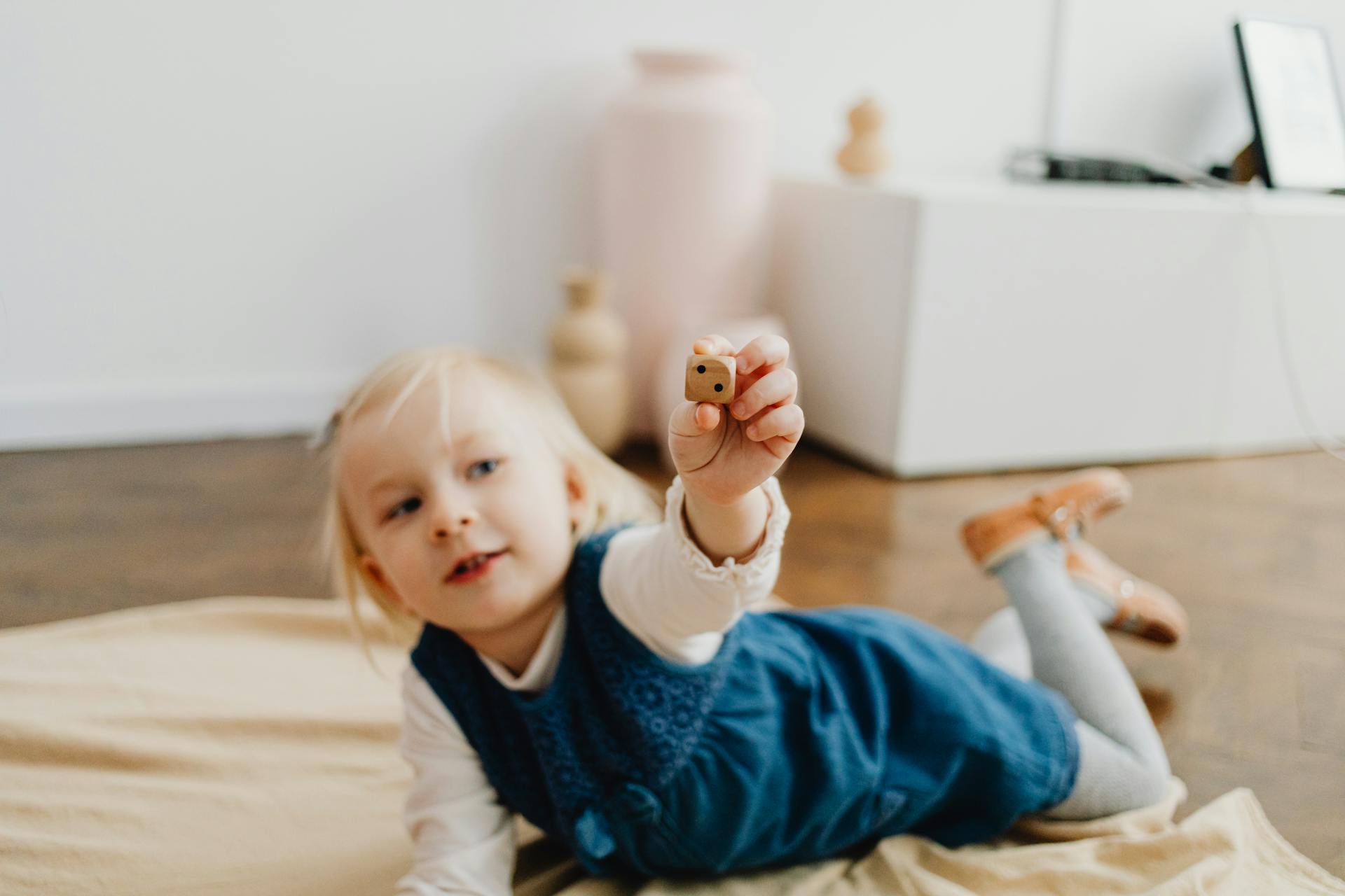 Girl Holding a Die