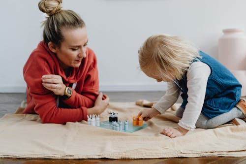 Free Mother and Daughter Playing on the Floor Stock Photo