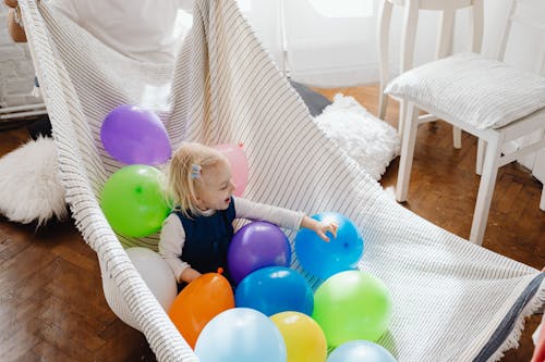 Free A Young Girl Playing a Balloons Stock Photo