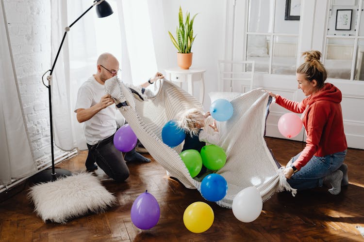 Parents Playing With Their Daughter