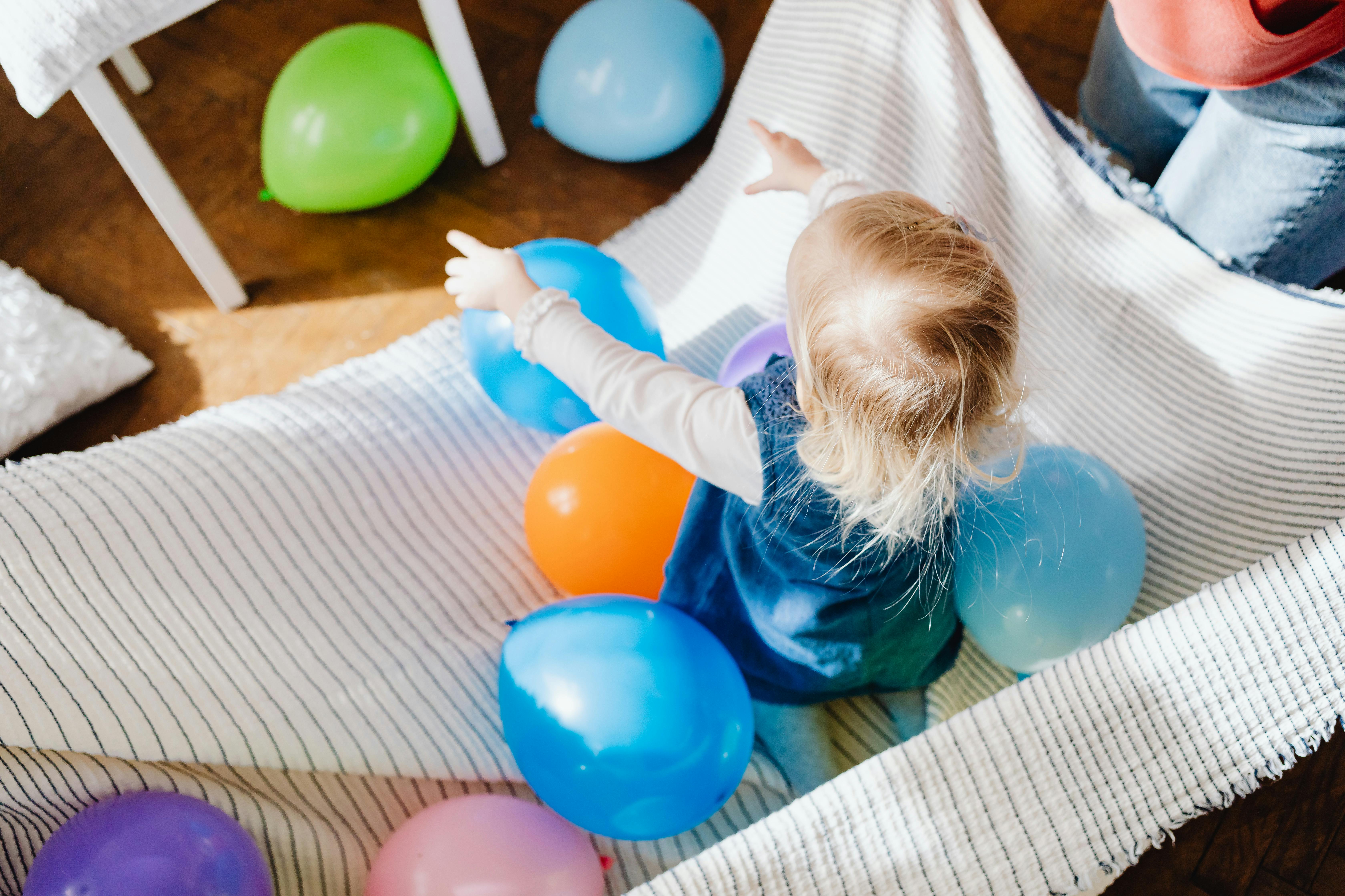 a child playing balloons