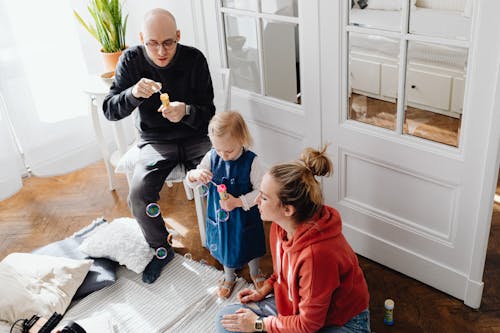 A Family Blowing Bubbles in the Living Room