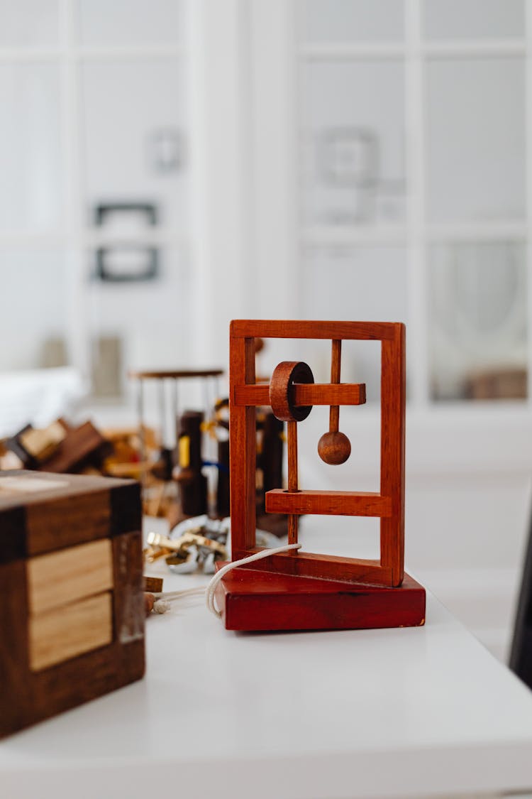 A Wooden Puzzle On A White Surface