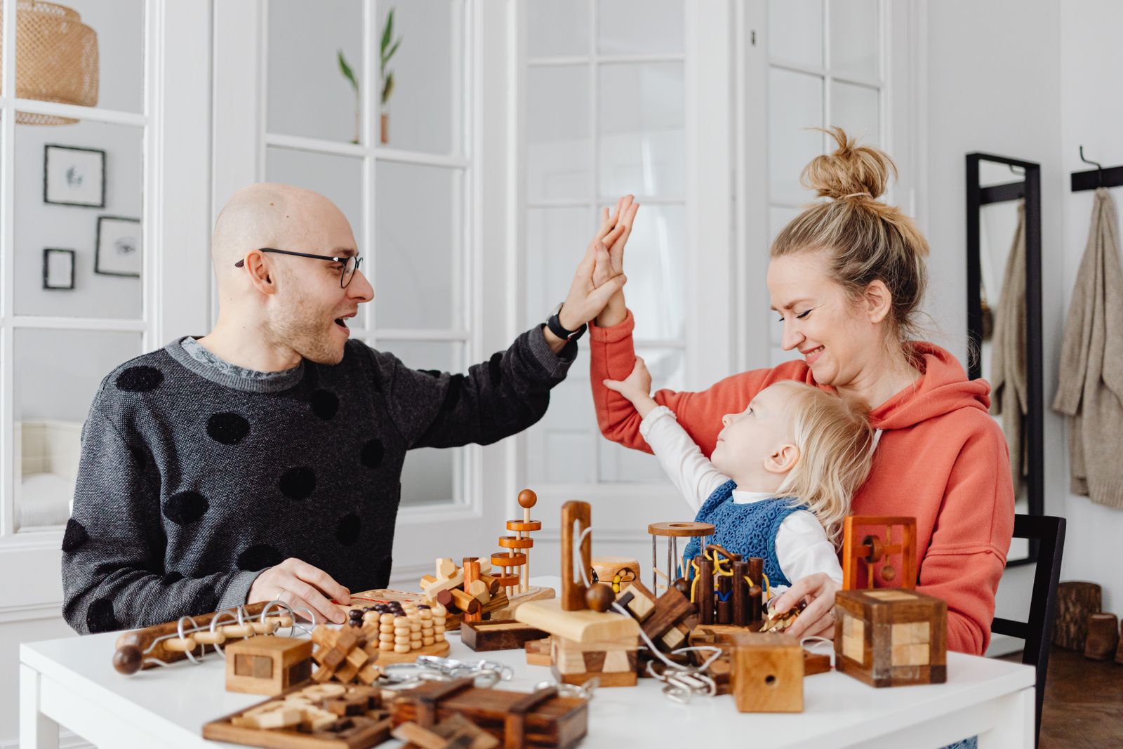 Family enjoying wooden puzzles and educational games together at home