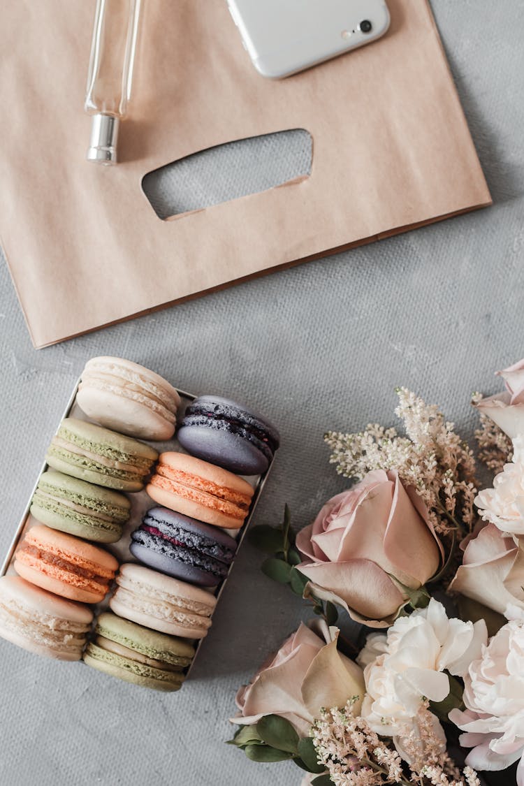 Pack Of Macarons And Flowers On Table