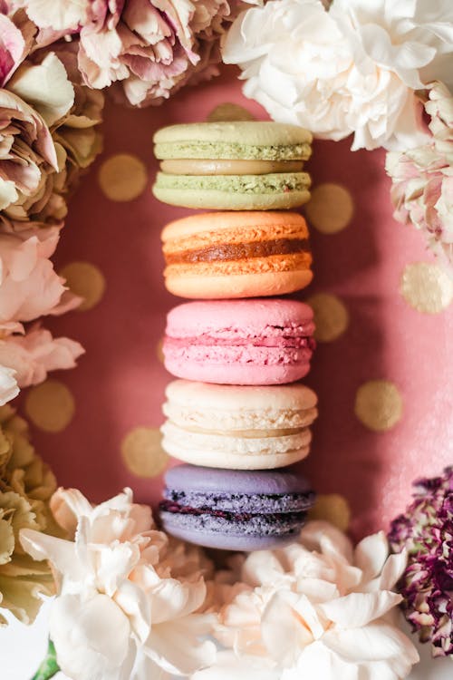 A French Macarons Surrounded with Flower Petals