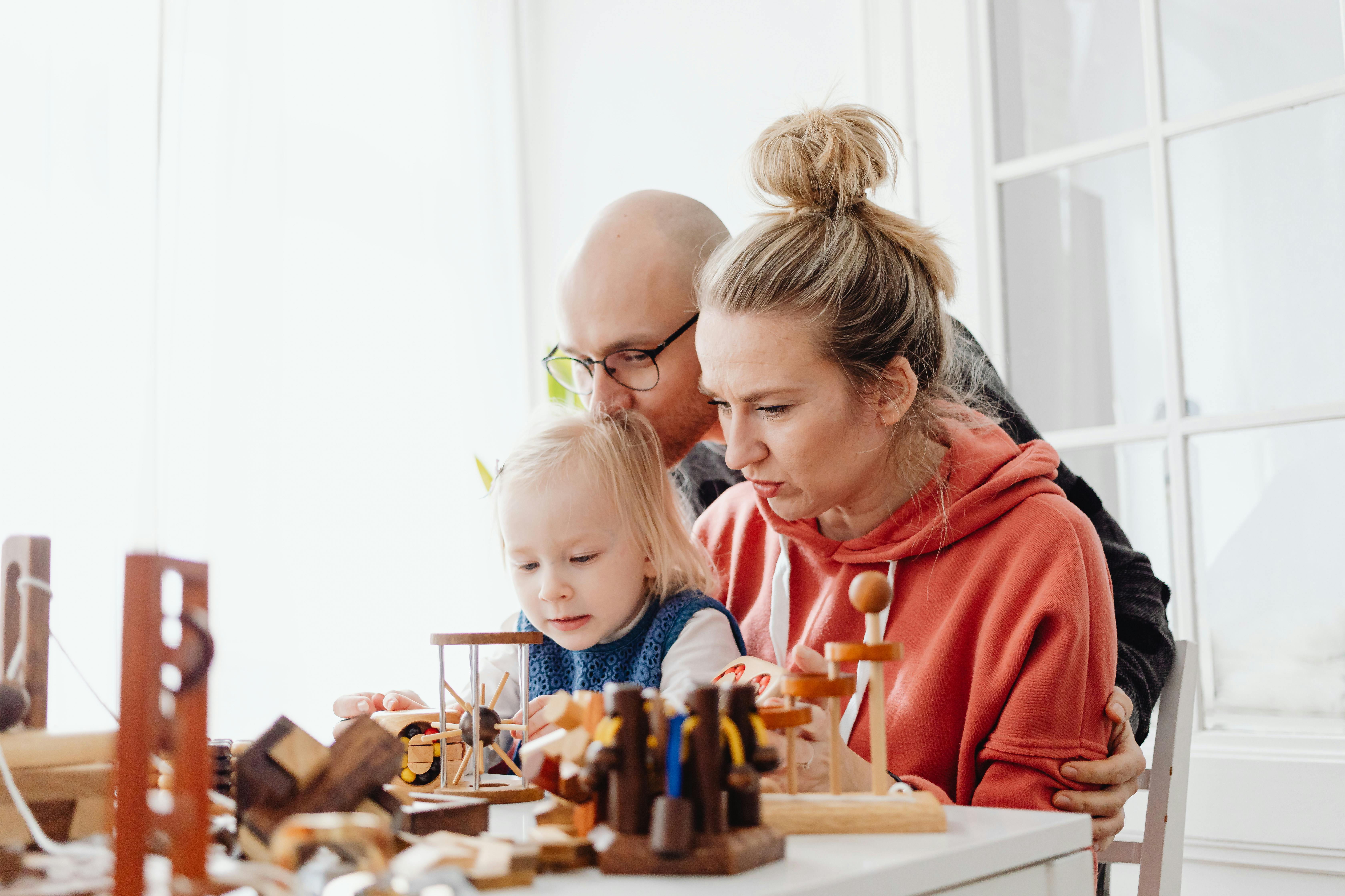 a family playing wooden toys together