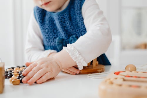 Child Playing with Wooden Toys
