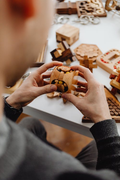 Free A Person Holding a Wooden Toys Stock Photo