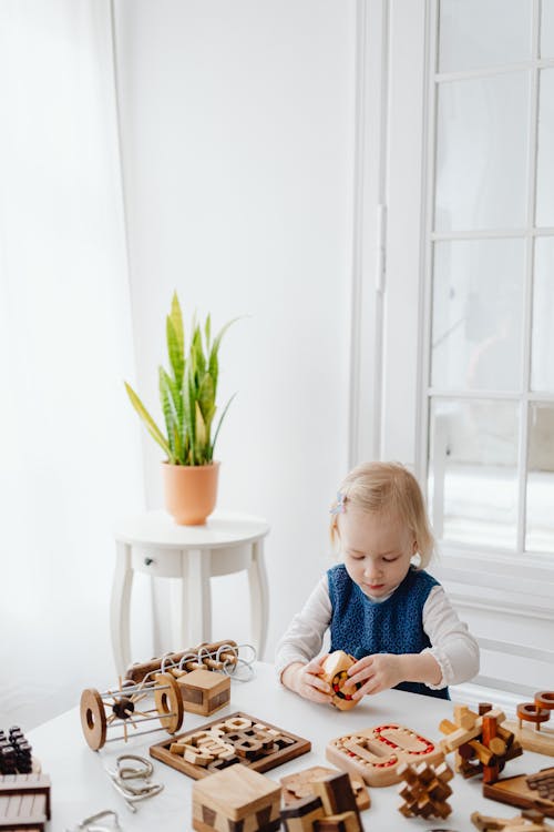 A Young Girl Playing Wooden Toys