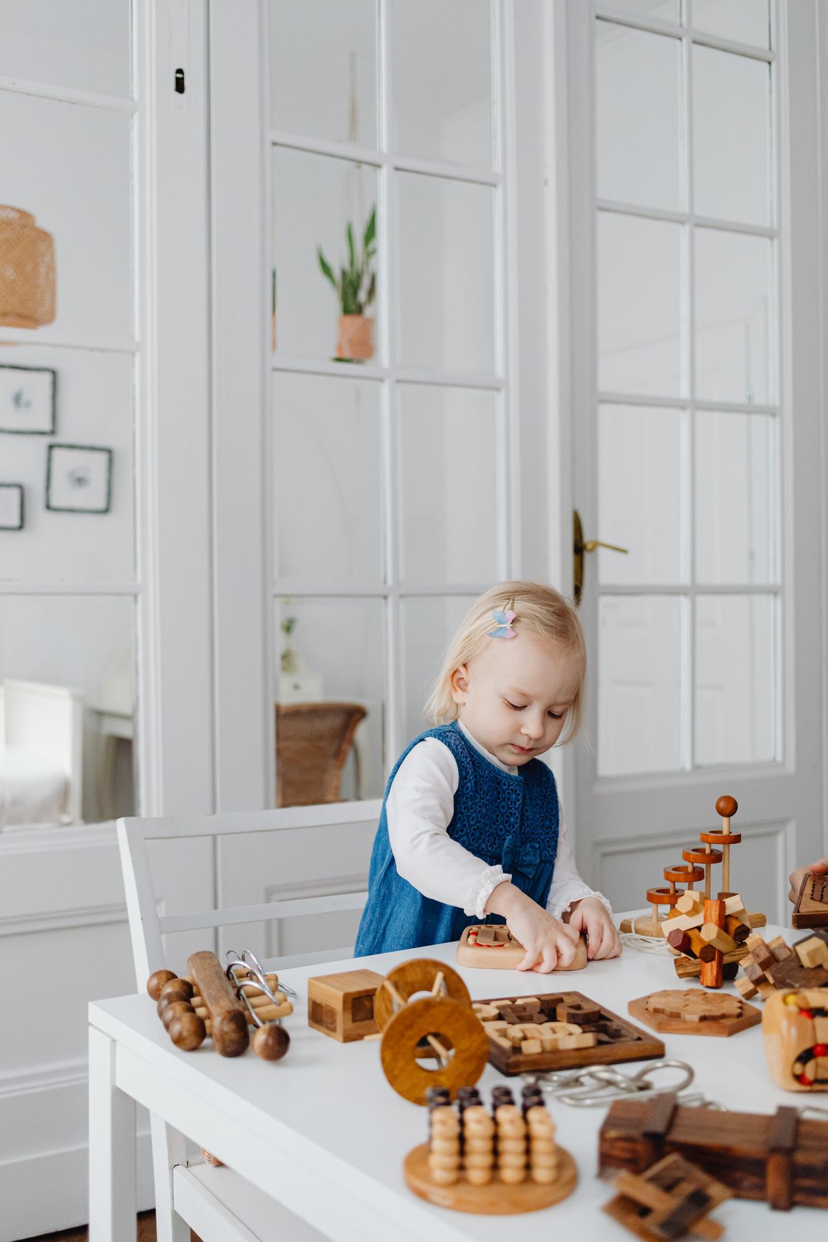 Child playing with wooden educational learning toys at a table