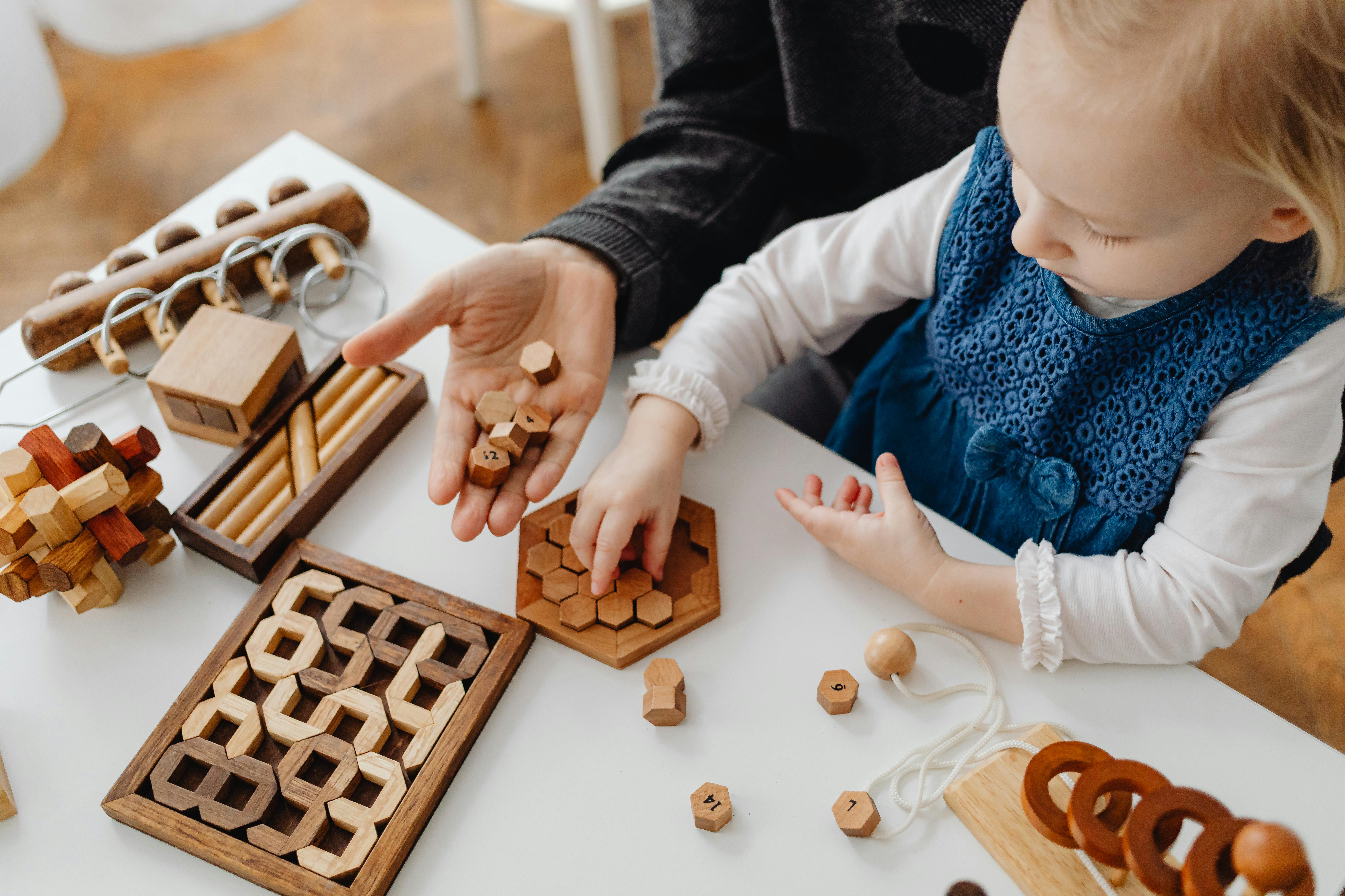 Free A High Angle Shot of a Young Girl Playing Wooden Toys Stock Photo
