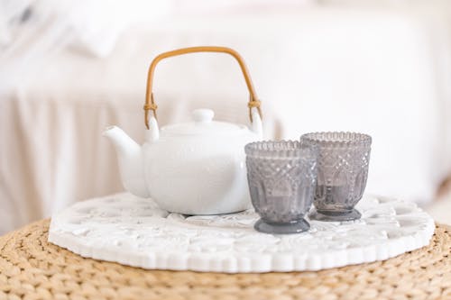 A Teapot and Woven Glasses on a Table