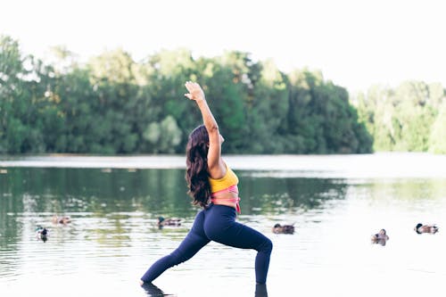 Free A Woman Doing Yoga on the Lake Stock Photo